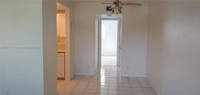 a view of a room with wooden floor and tiles