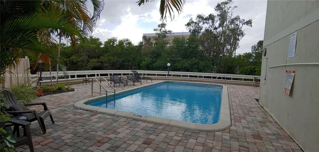 a view of a swimming pool with a chair