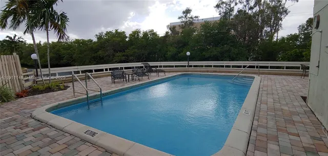 a view of a swimming pool with a table and chairs