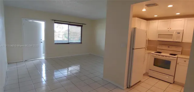 a kitchen with stainless steel appliances granite countertop a refrigerator and a stove