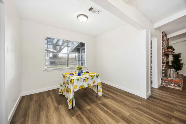 a dining room with furniture wooden floor and a rug