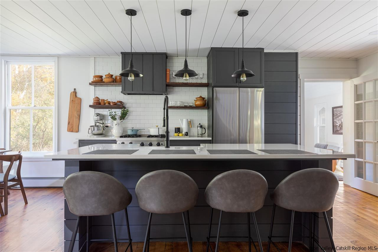 9 Clark A Road Woodbourne, NY 12788 - Photo 13 of 35 a kitchen with stainless steel appliances a dining table chairs and a window