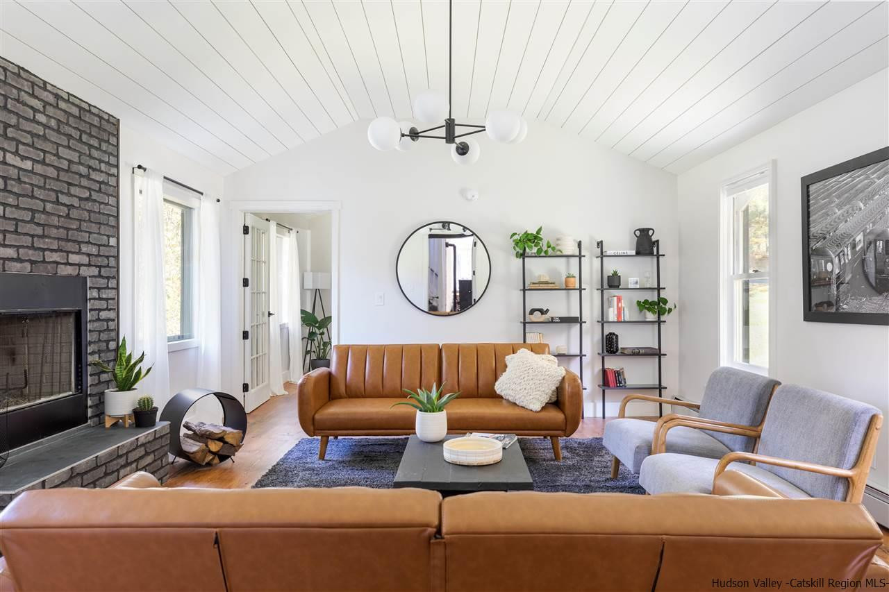 9 Clark A Road Woodbourne, NY 12788 - Photo 2 of 35 a living room with furniture a rug and a fireplace