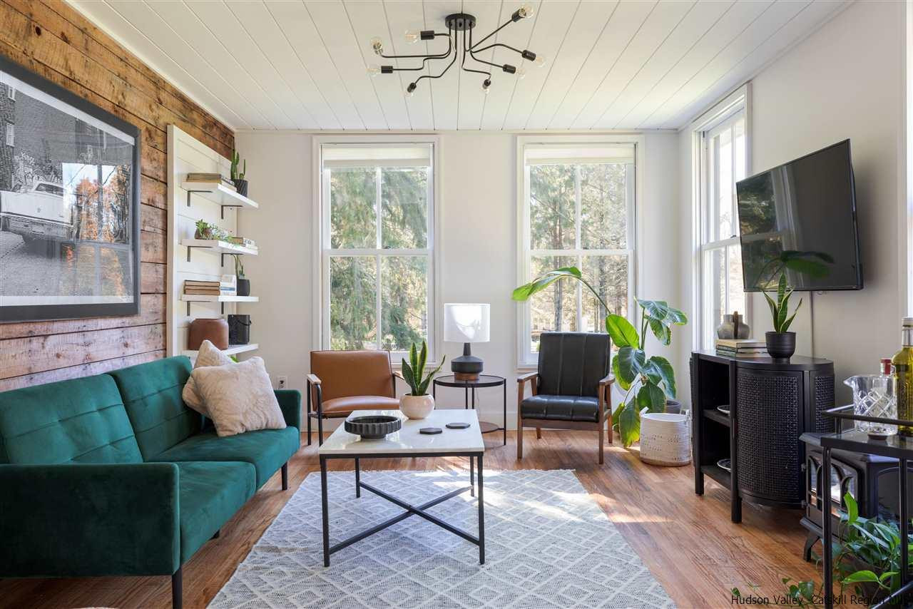 9 Clark A Road Woodbourne, NY 12788 - Photo 3 of 35 a living room with furniture a flat screen tv and a large window