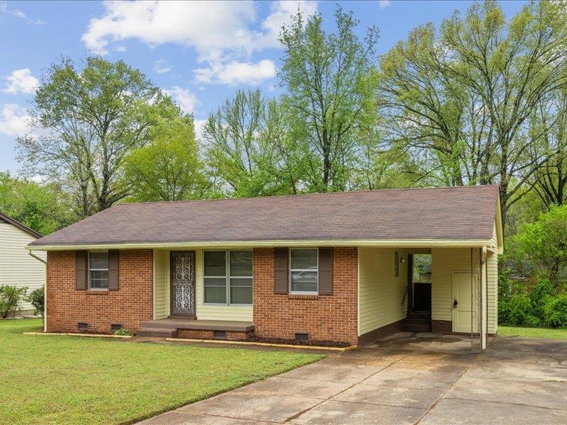 1599 Butterworth Road Memphis, TN 38116 - Photo 3 of 26 a front view of a house with a yard and garage
