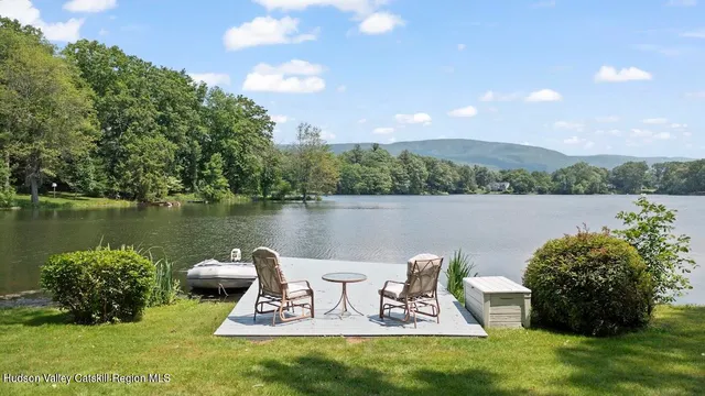 a view of a lake with a table and chairs