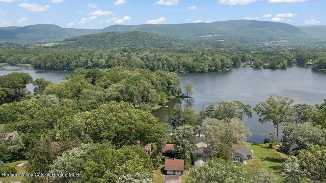 an aerial view of residential house with outdoor space and lake view