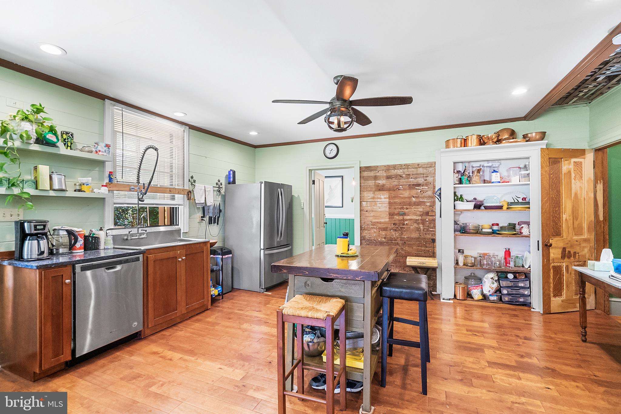 143 Barto Road Barto, PA 19504 - Photo 16 of 37 a kitchen with stainless steel appliances kitchen island granite countertop a table chairs in it and wooden floors