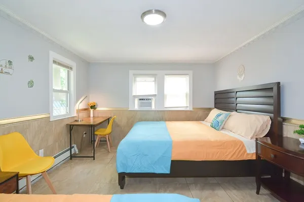 a bedroom with a bed and window