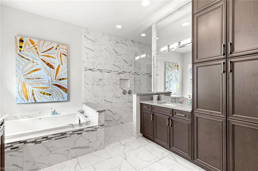 4366 Caldera Circle Naples, FL 34119 - Photo 13 of 41 a bathroom with a bathtub sink and mirror