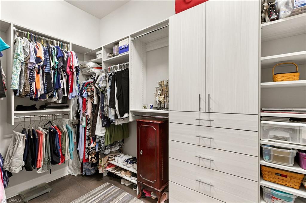 4366 Caldera Circle Naples, FL 34119 - Photo 14 of 41 a view of walk in closet with clothes and shoes