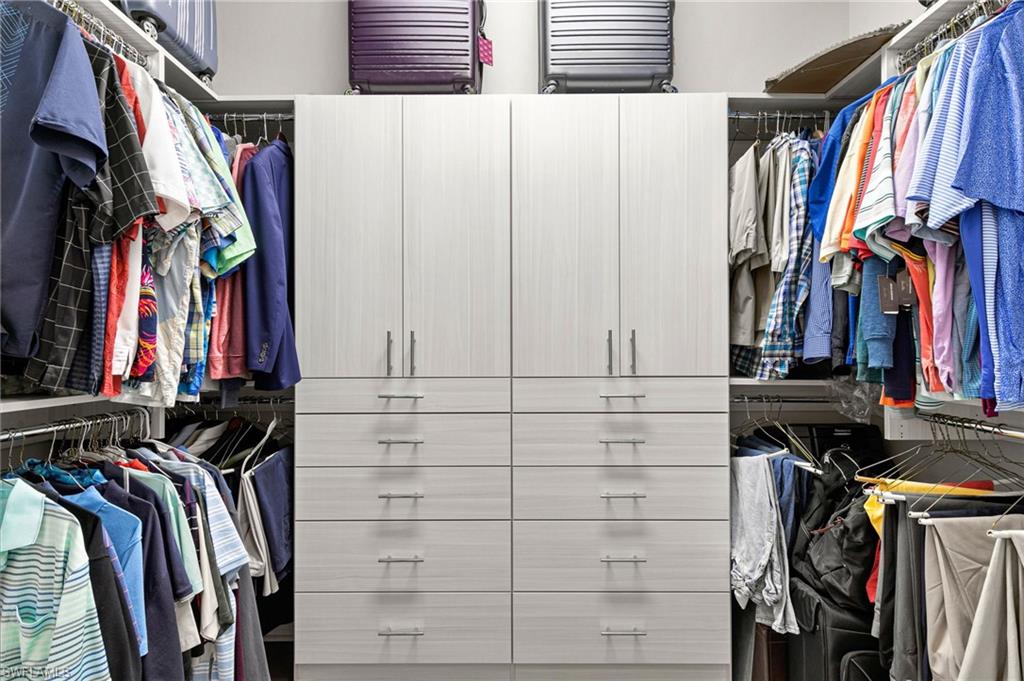 4366 Caldera Circle Naples, FL 34119 - Photo 15 of 41 a view of walk in closet with clothes and shoes