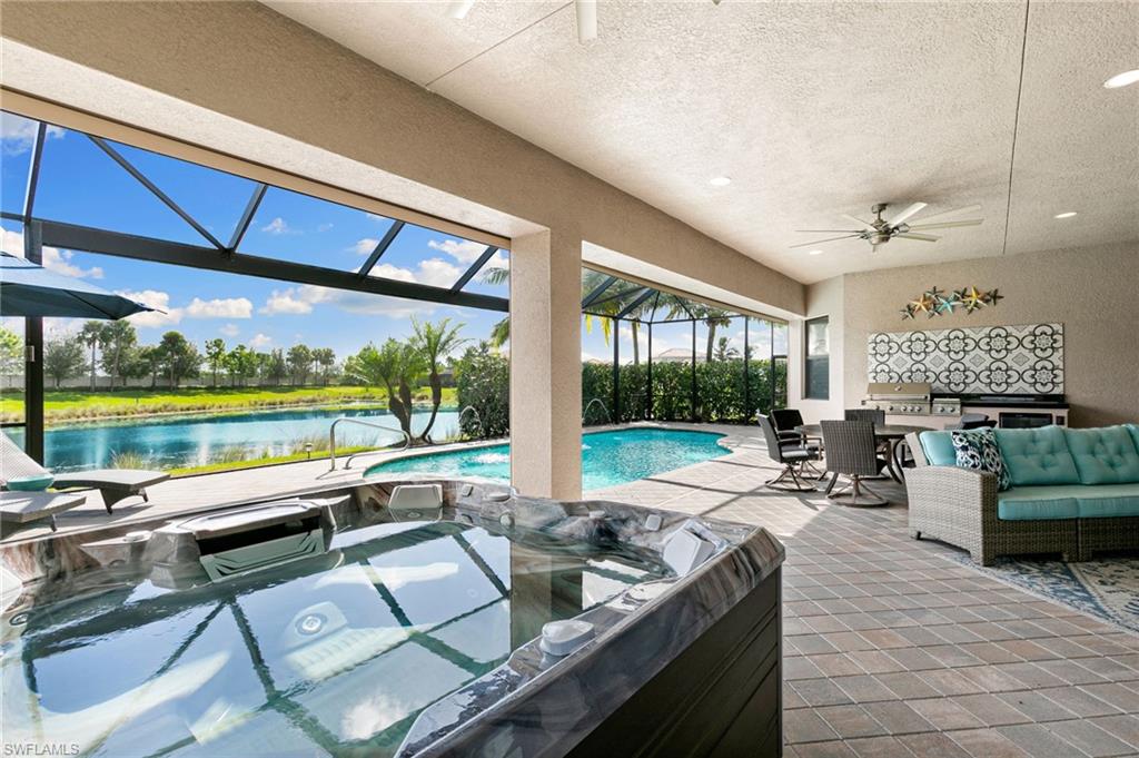 4366 Caldera Circle Naples, FL 34119 - Photo 22 of 41 a living room with furniture and a floor to ceiling window