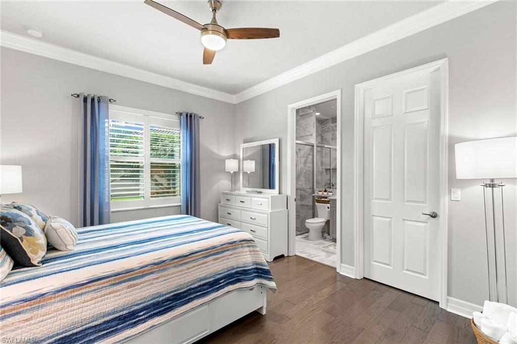 4366 Caldera Circle Naples, FL 34119 - Photo 23 of 41 a bedroom with a bed and a chandelier