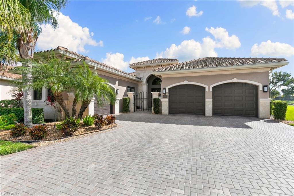 4366 Caldera Circle Naples, FL 34119 - Photo 3 of 41 a front view of a house with a yard and garage