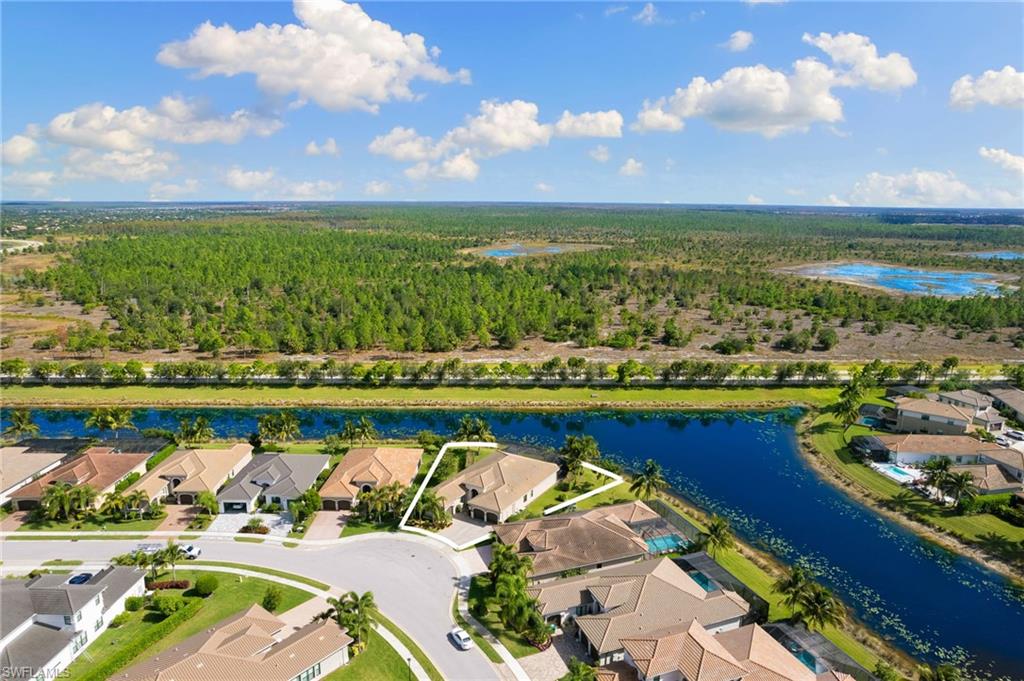 4366 Caldera Circle Naples, FL 34119 - Photo 36 of 41 a view of a lake with a houses