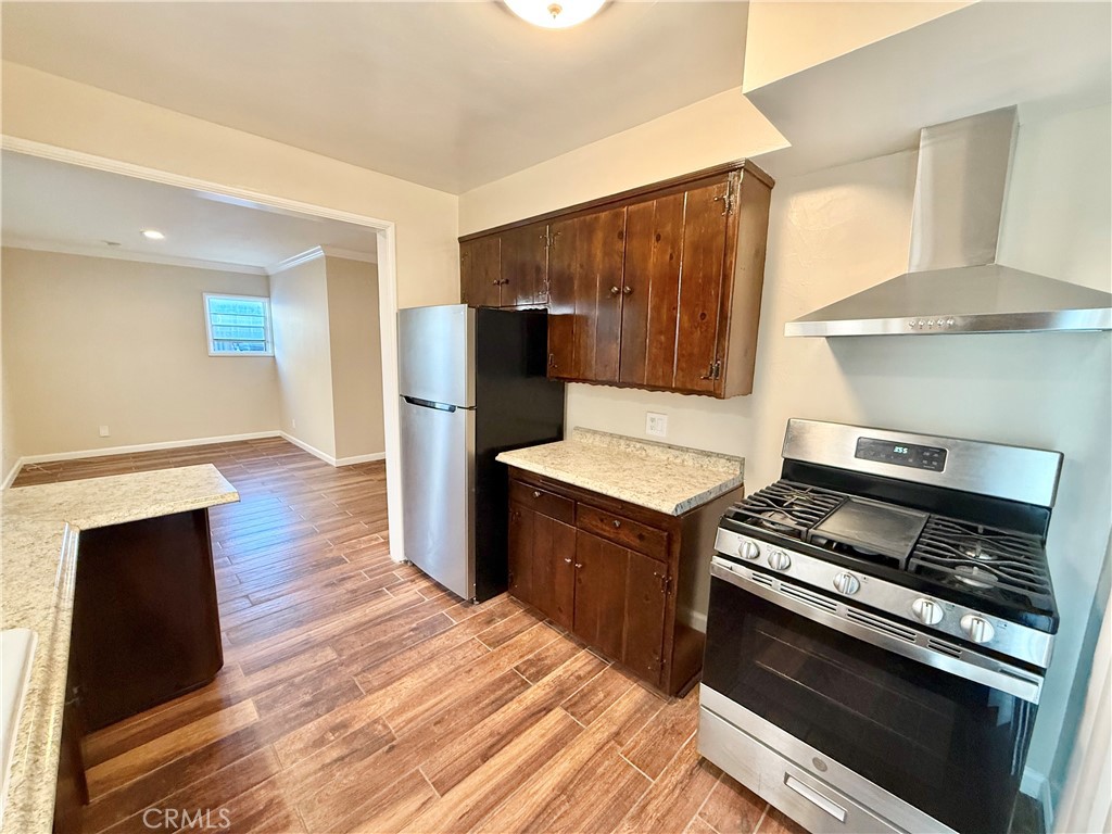 24 10th Court Hermosa Beach, CA 90254 - Photo 13 of 31 a kitchen with wooden floors and appliances