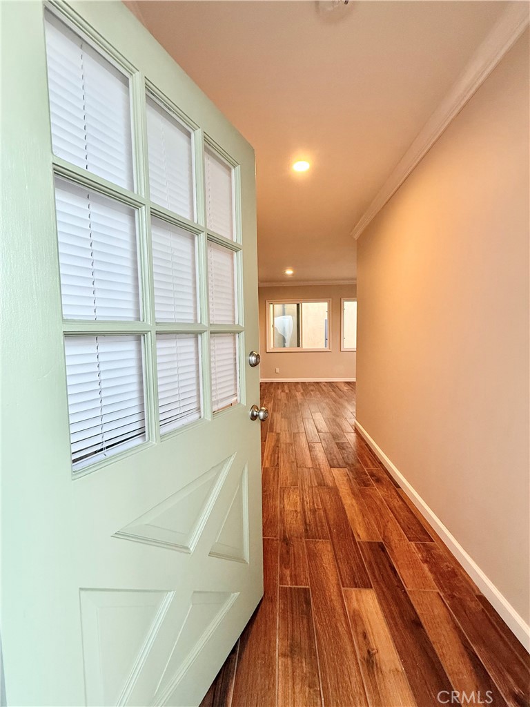 24 10th Court Hermosa Beach, CA 90254 - Photo 4 of 31 a view of an empty room with wooden floor and a window