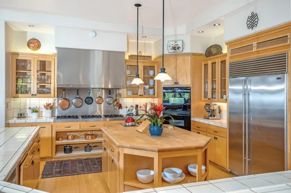 a kitchen with a sink a stove and a refrigerator