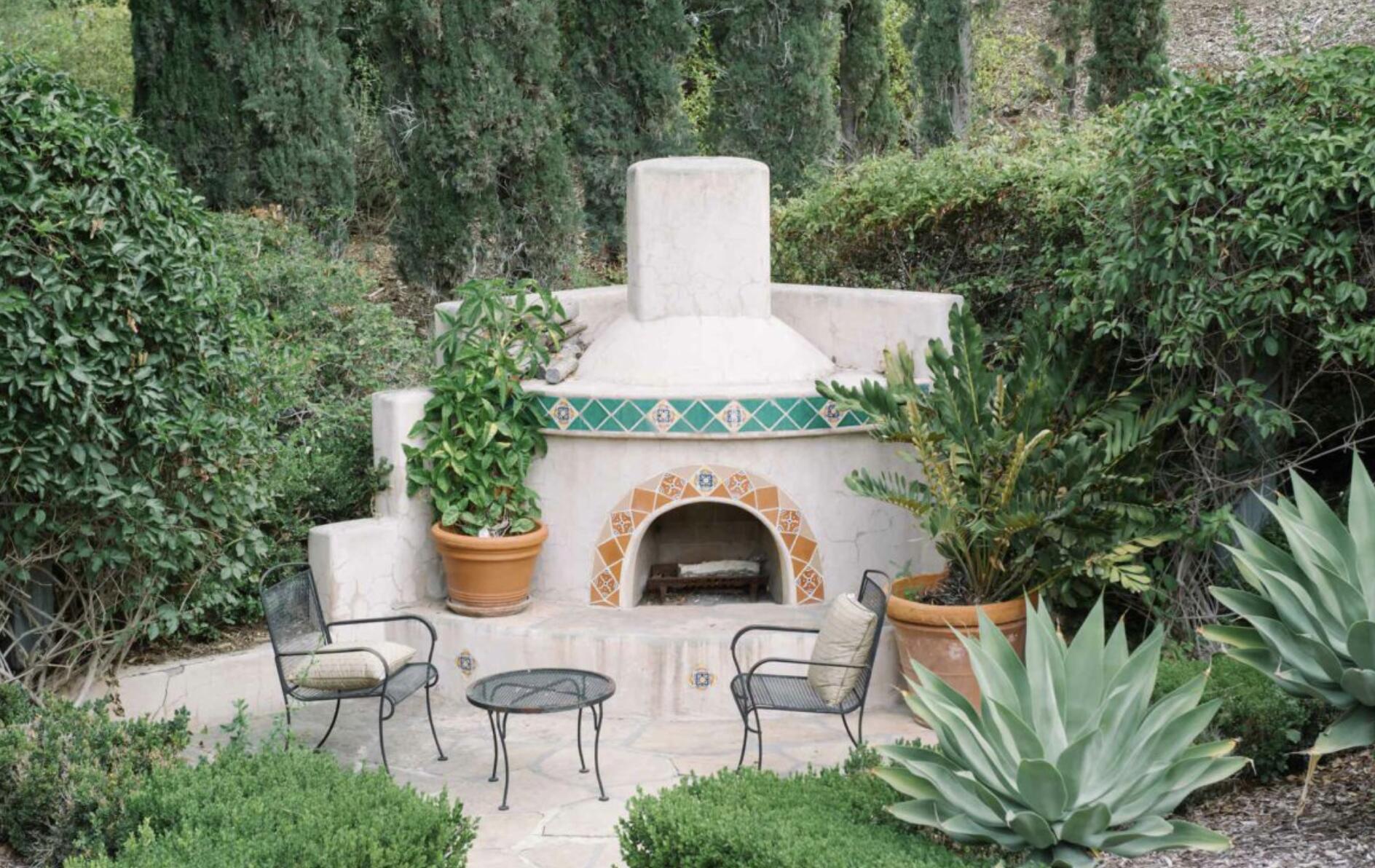 3756 Foothill Road Santa Barbara, CA 93105 - Photo 44 of 70 a view of a patio with table and chairs and potted plants