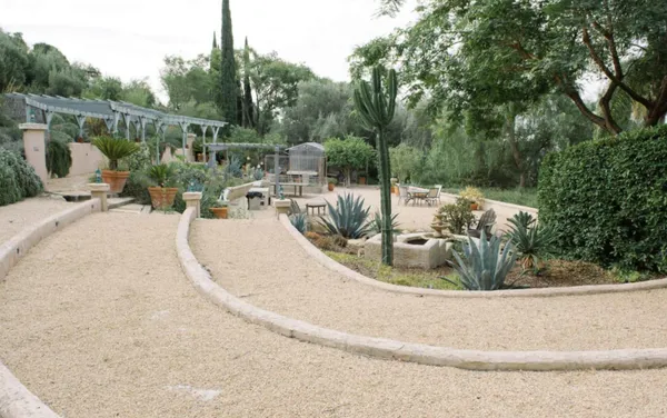 a view of a patio with couches table and chairs and potted plants