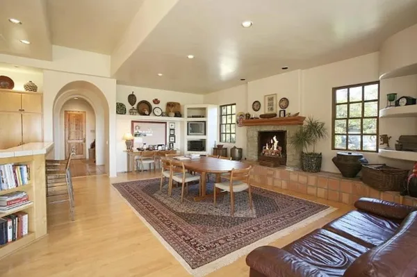 a living room with furniture fireplace and window