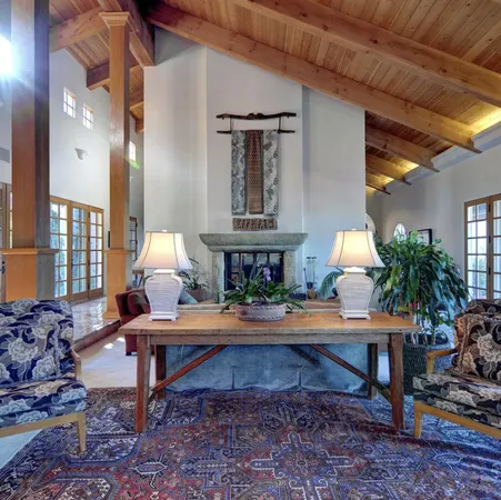 a living room with lots of furniture and a large window