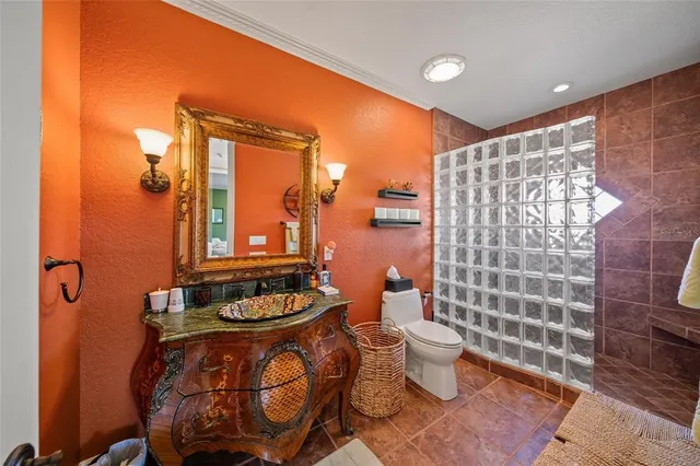 a view of a patio with table and chairs potted plants and floor to ceiling window