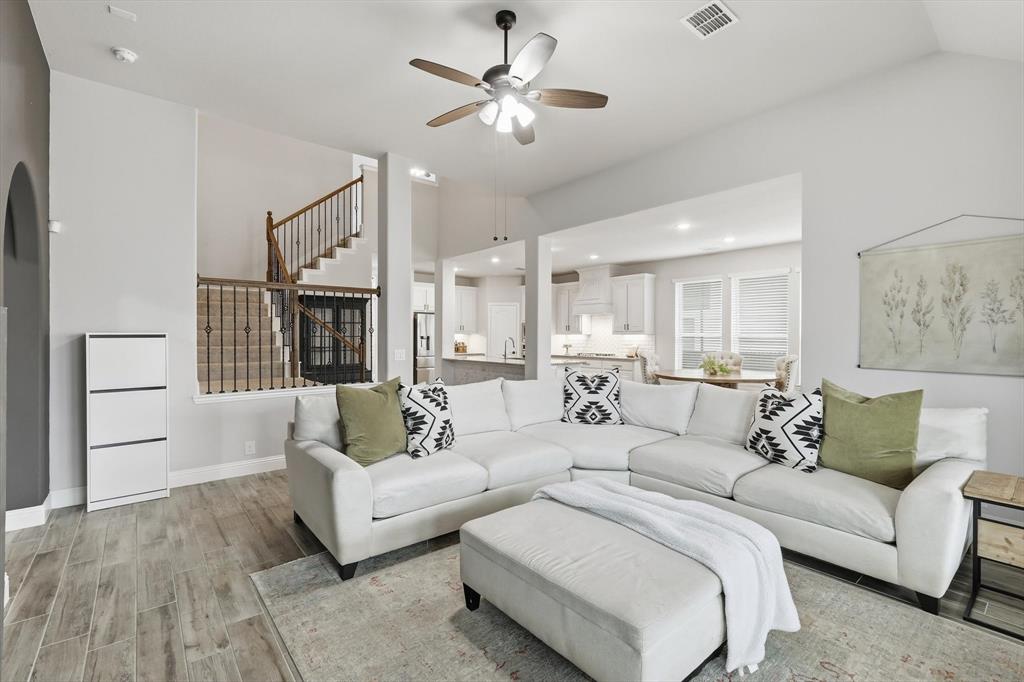 924 Timber Ridge Drive Justin, TX 76247 - Photo 16 of 32 Open-concept living area featuring wood-finish flooring, a contemporary ceiling fan, and a light color palette