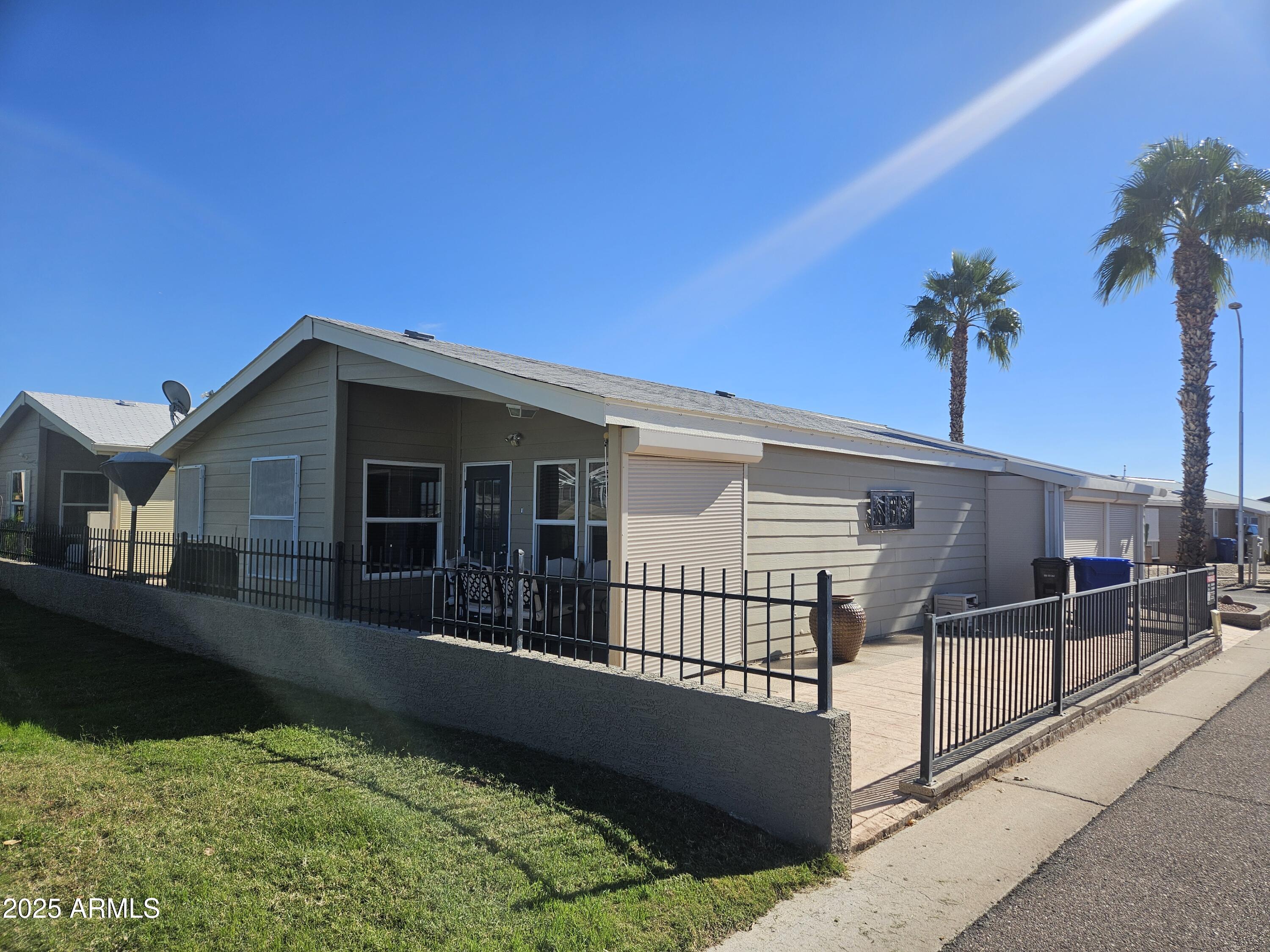 650 North Hawes Road, Unit 4820 Mesa, AZ 85207 - Photo 1 of 54 a view of a house with a wooden fence