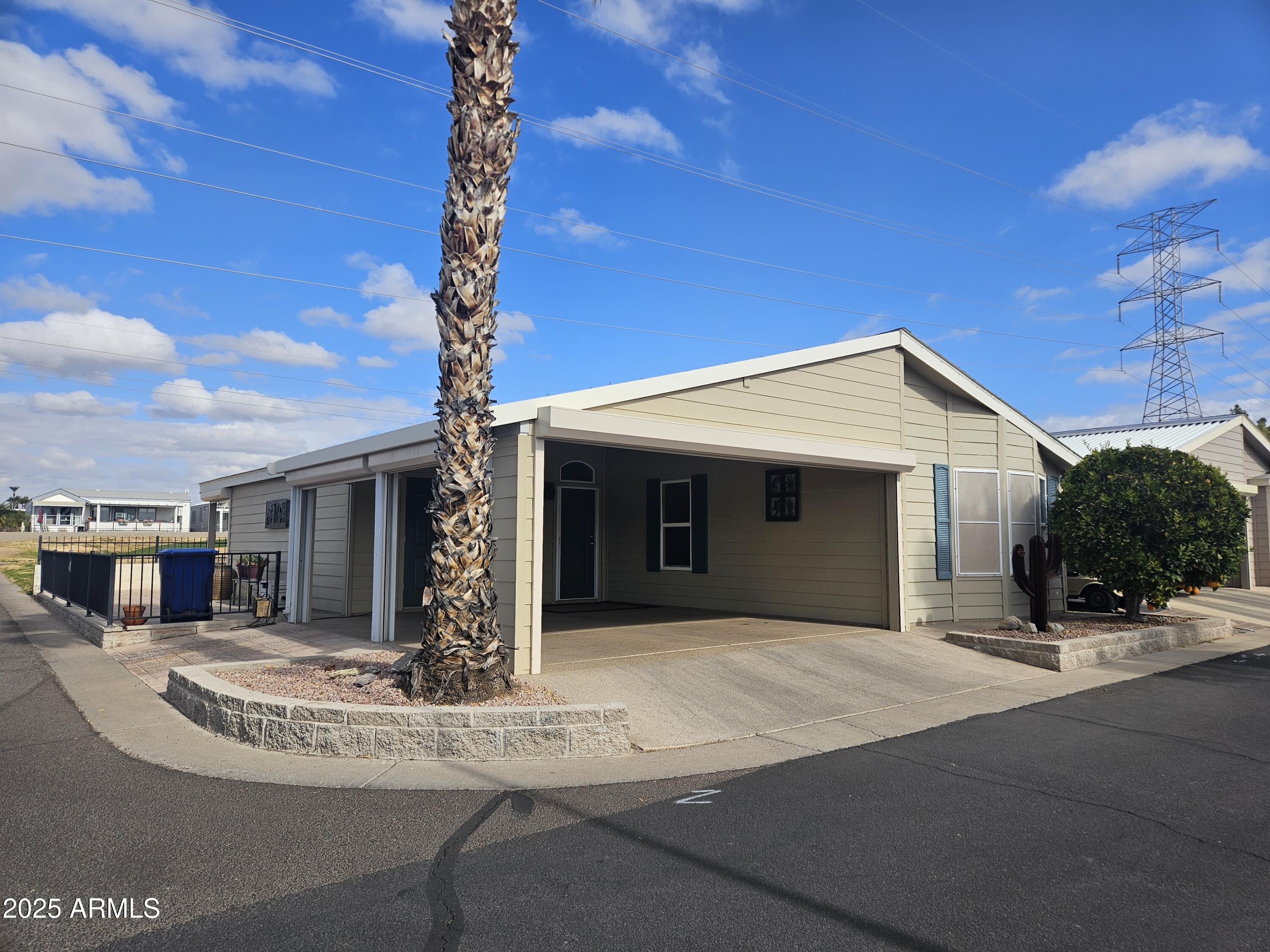 650 North Hawes Road, Unit 4820 Mesa, AZ 85207 - Photo 14 of 54 a view of a house with a yard and garage