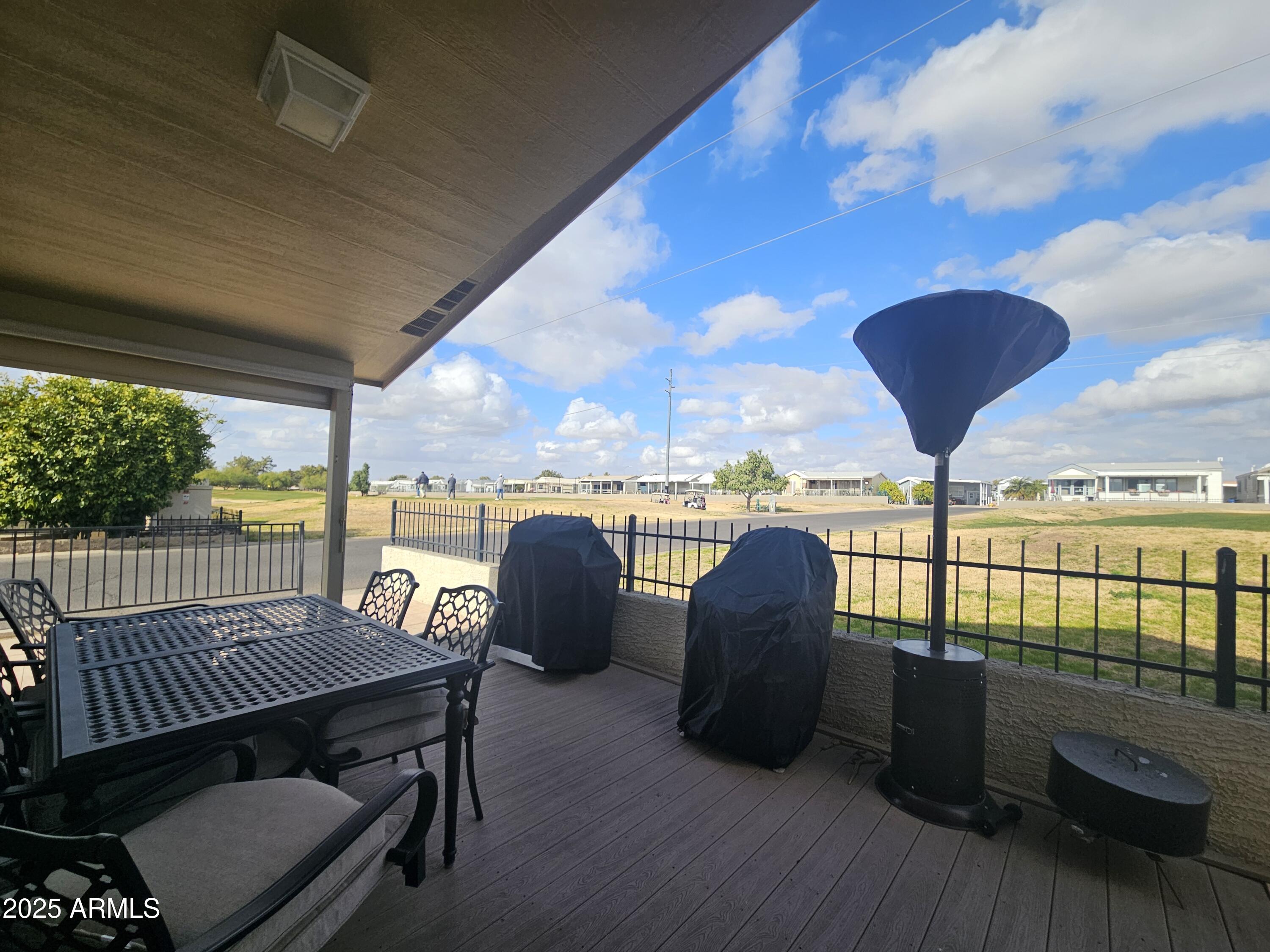 650 North Hawes Road, Unit 4820 Mesa, AZ 85207 - Photo 15 of 54 a view of a balcony with furniture and a floor to ceiling window