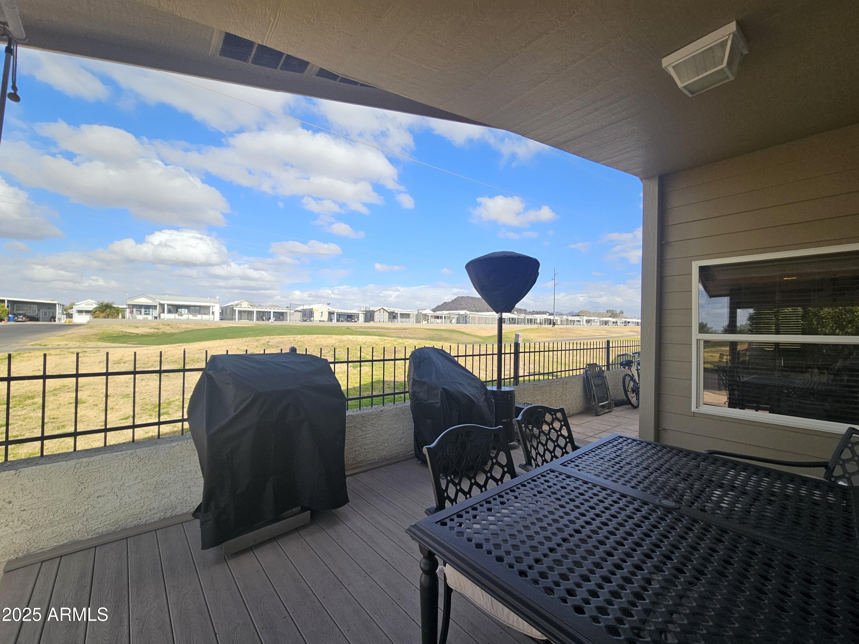650 North Hawes Road, Unit 4820 Mesa, AZ 85207 - Photo 16 of 54 a balcony with furniture and wooden floor