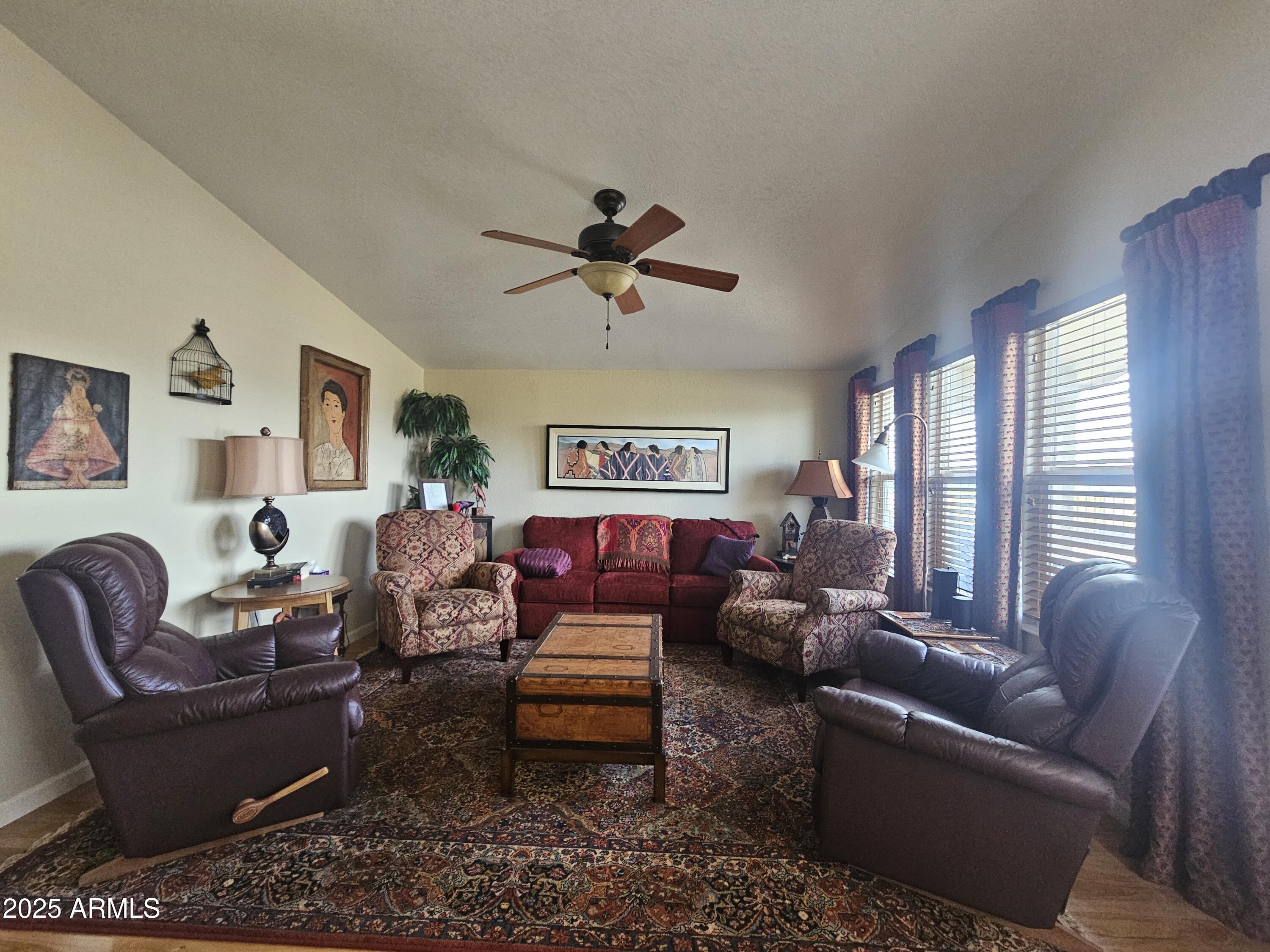 650 North Hawes Road, Unit 4820 Mesa, AZ 85207 - Photo 29 of 54 a living room with furniture a ceiling fan and a window