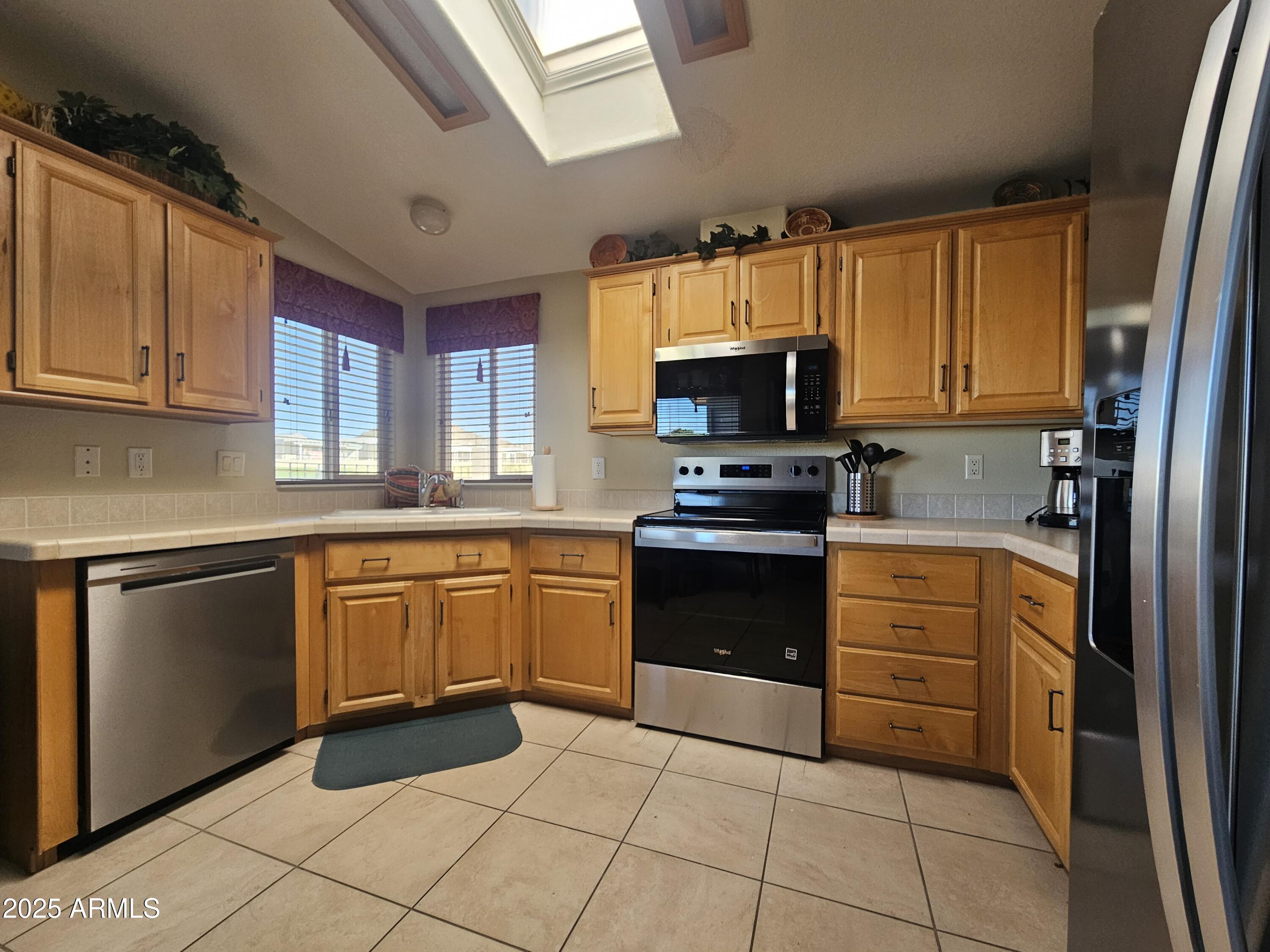 650 North Hawes Road, Unit 4820 Mesa, AZ 85207 - Photo 30 of 54 a kitchen with granite countertop a stove top oven microwave and cabinets