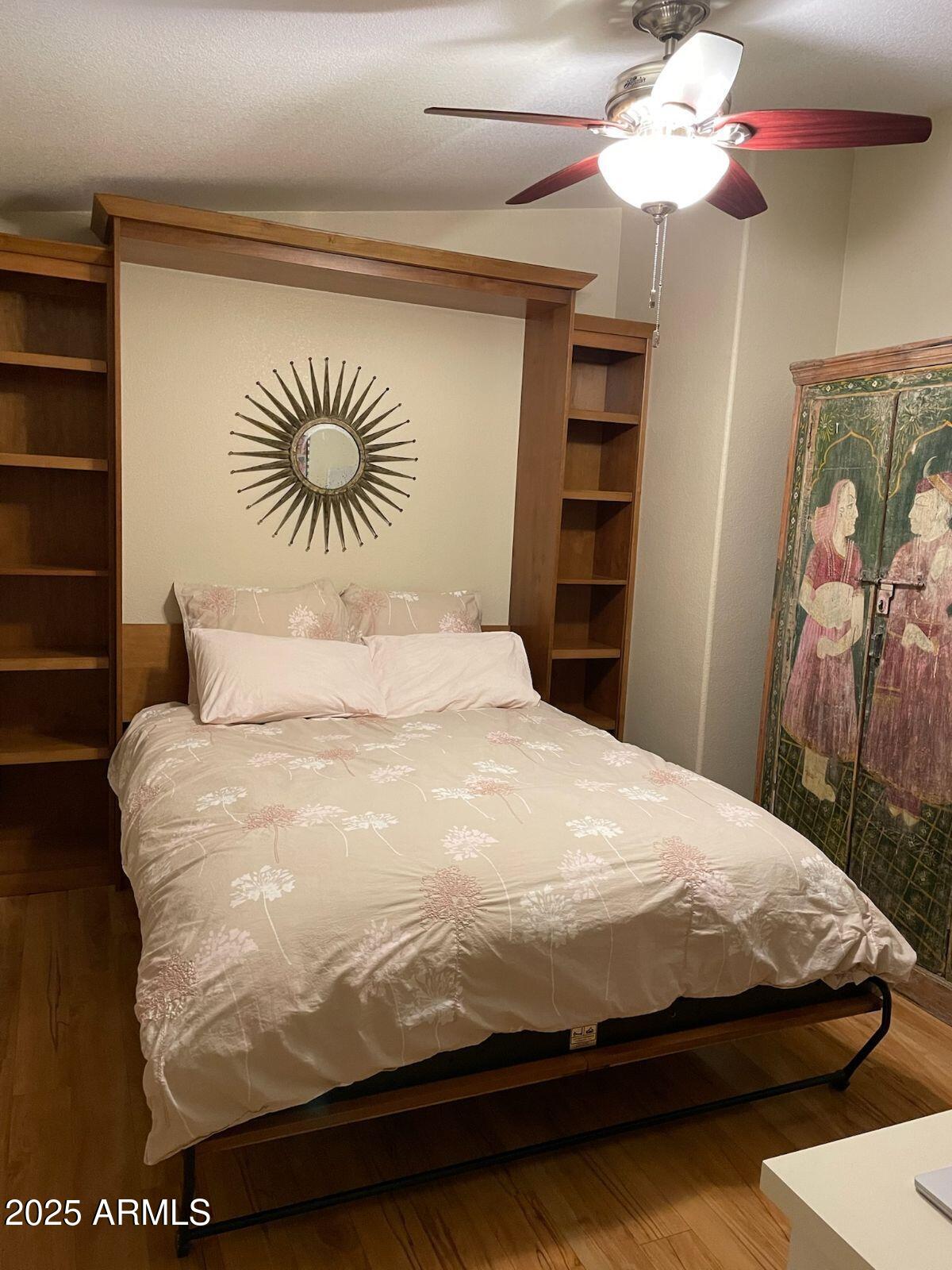 650 North Hawes Road, Unit 4820 Mesa, AZ 85207 - Photo 32 of 54 a bedroom with a bed and a chandelier