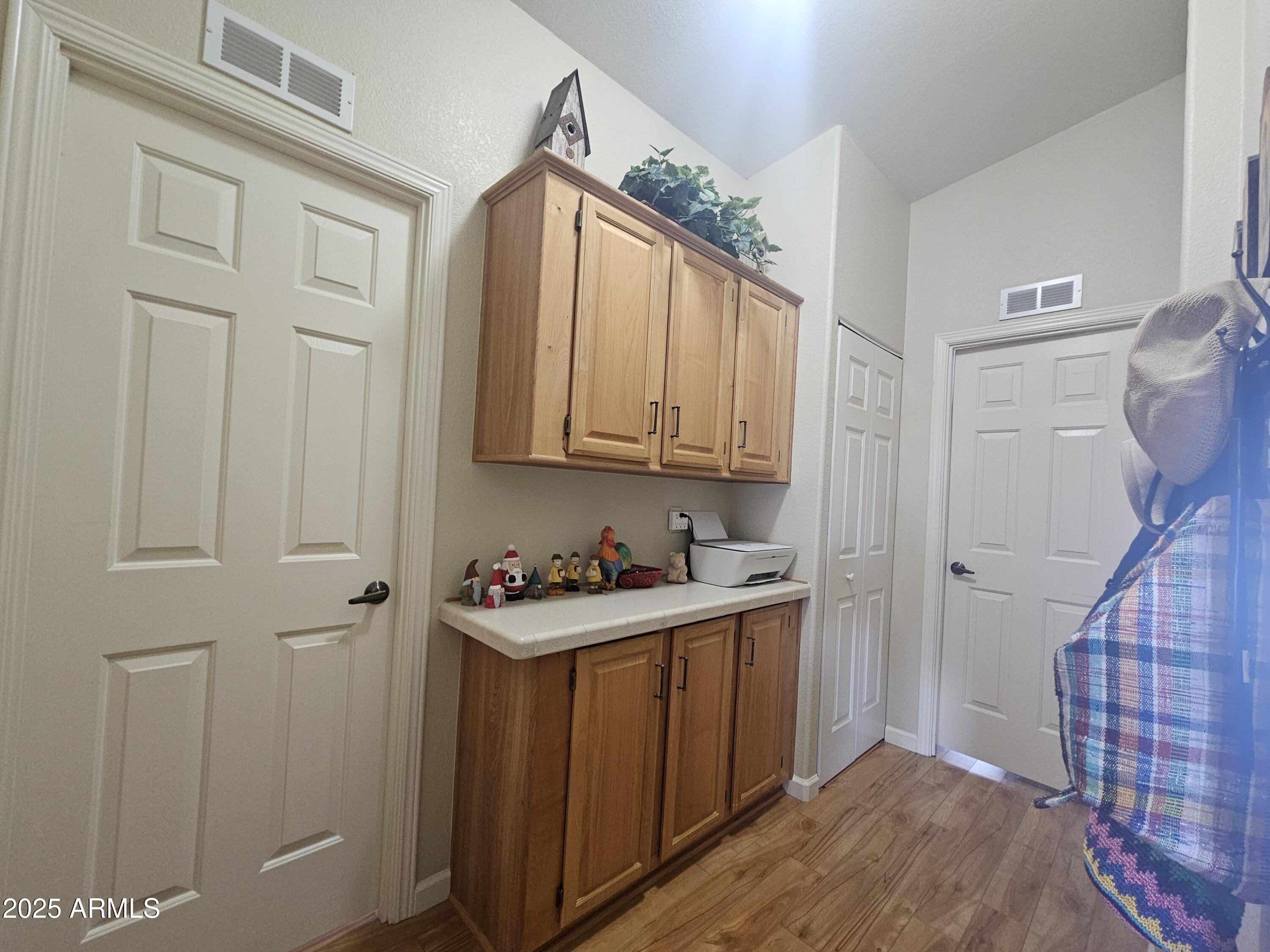 650 North Hawes Road, Unit 4820 Mesa, AZ 85207 - Photo 35 of 54 a view of a storage and utility room with wooden floor