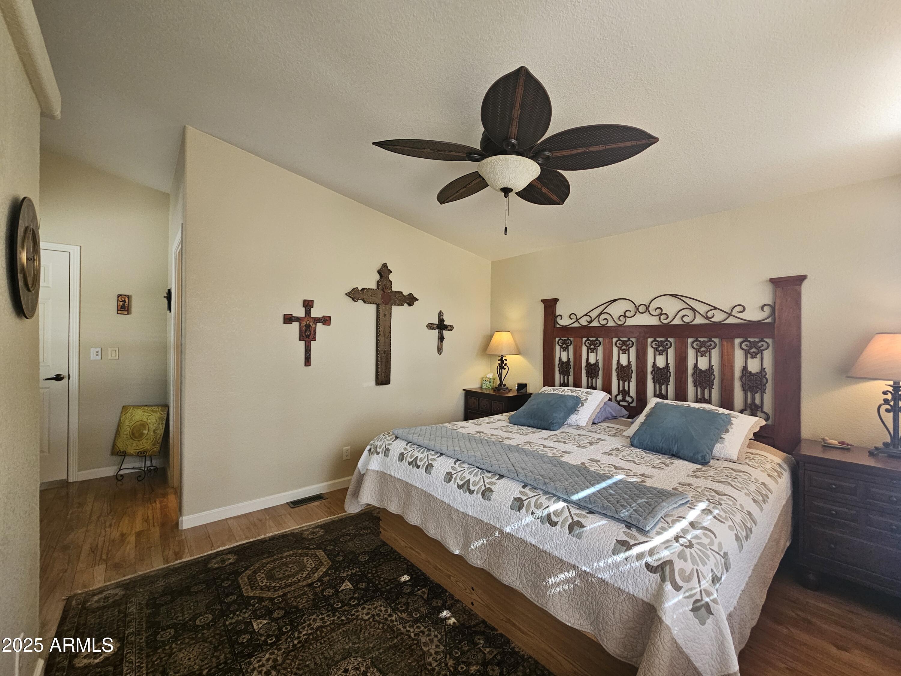 650 North Hawes Road, Unit 4820 Mesa, AZ 85207 - Photo 37 of 54 a bedroom with a bed and wooden floor