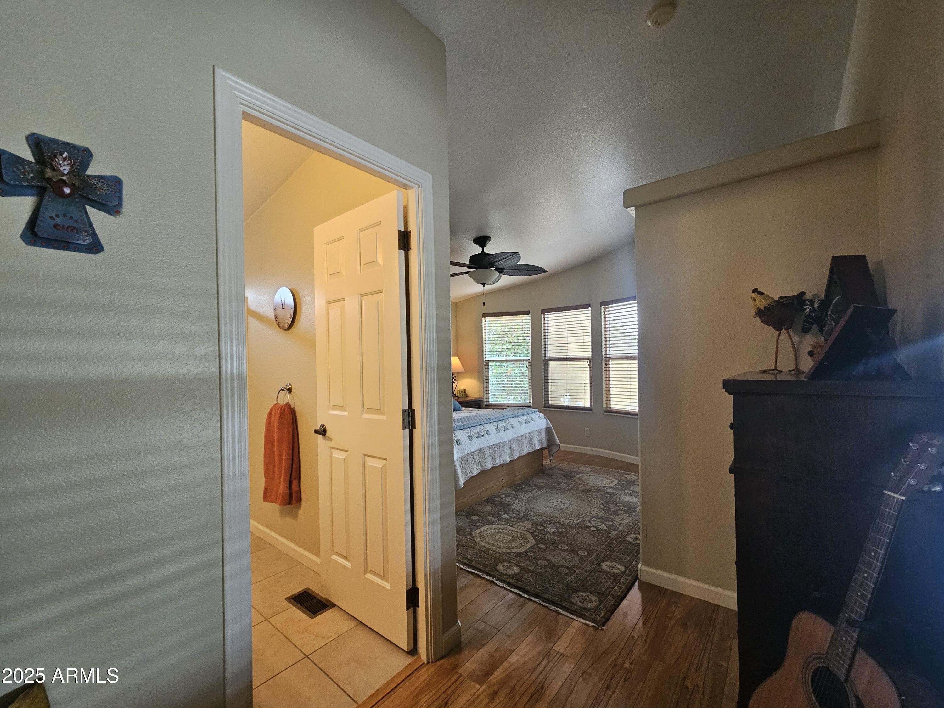 650 North Hawes Road, Unit 4820 Mesa, AZ 85207 - Photo 38 of 54 a view of a hallway with wooden floor and a bathroom