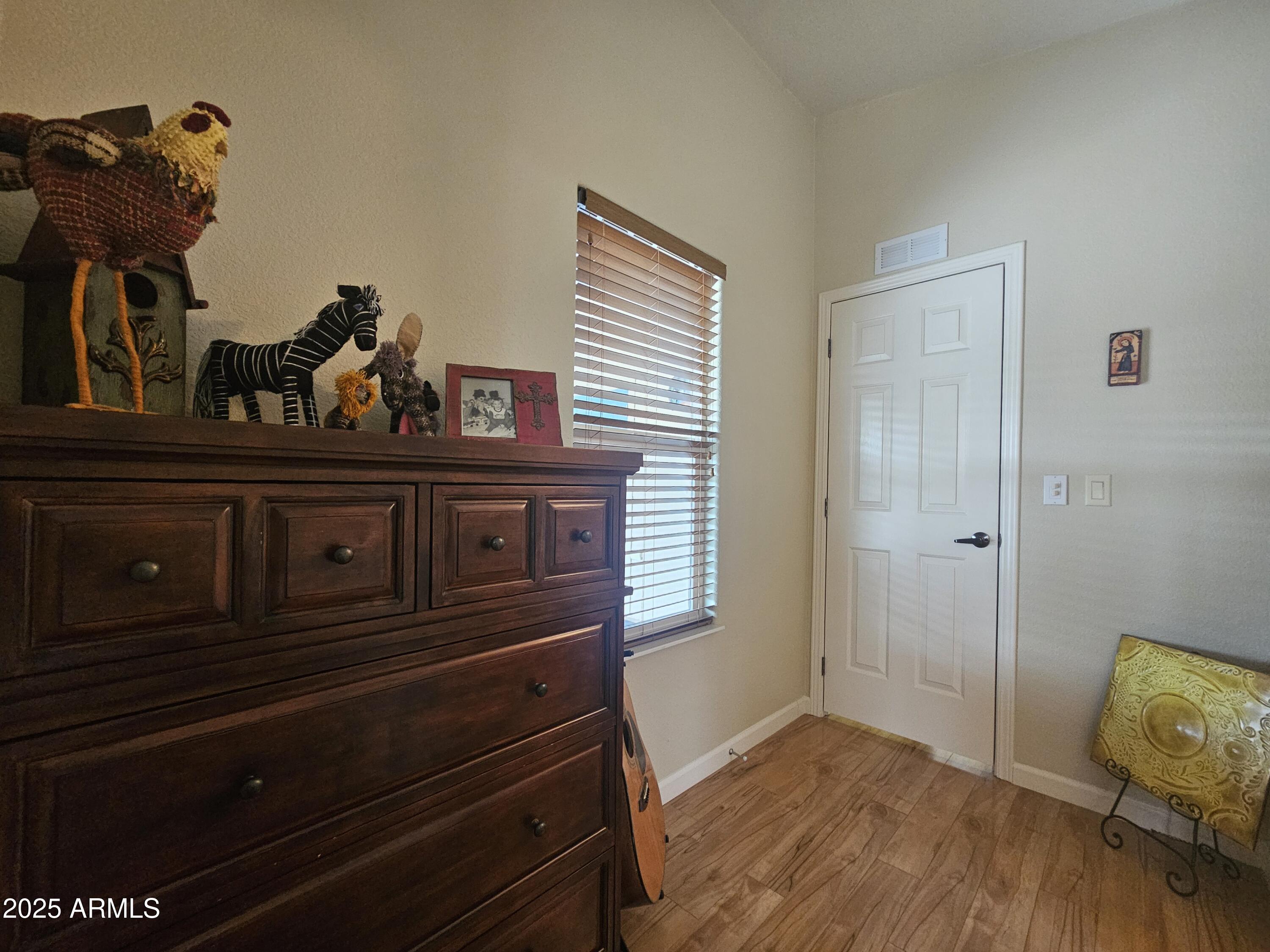 650 North Hawes Road, Unit 4820 Mesa, AZ 85207 - Photo 40 of 54 a view of a hallway with wooden floor and closet