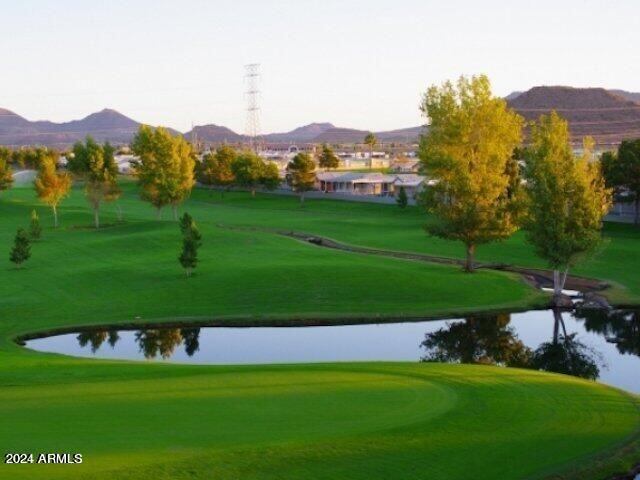 650 North Hawes Road, Unit 4820 Mesa, AZ 85207 - Photo 48 of 54 a view of a grassy field with mountains in the background