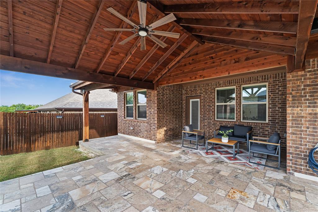 2908 Frio Road Little Elm, TX 75068 - Photo 21 of 26 Expansive covered patio featuring a wood-plank ceiling, exposed wood beams, and a ceiling fan