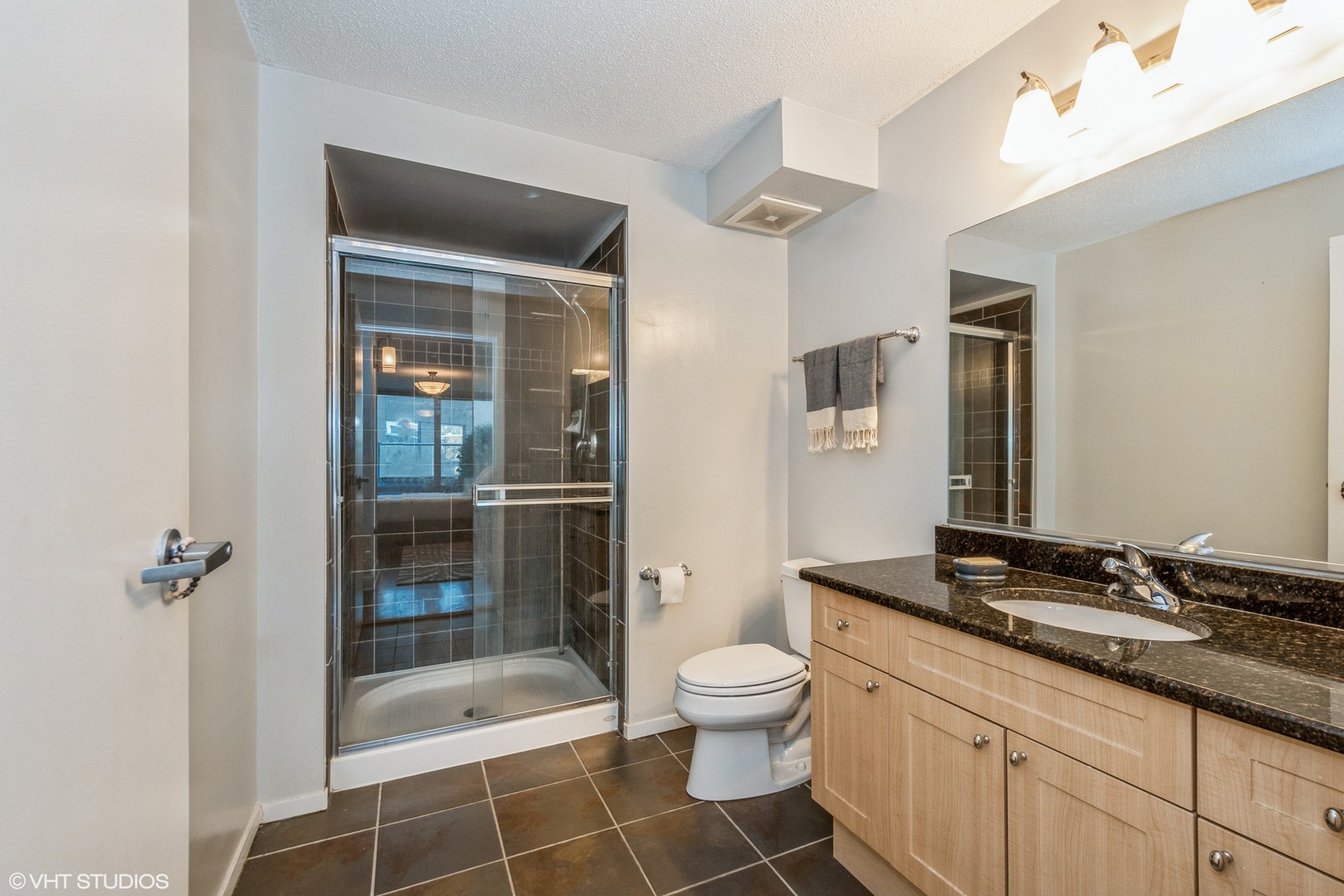 800 Elgin Road, Unit 517 Evanston, IL 60201 - Photo 13 of 20 a bathroom with a granite countertop sink toilet and shower