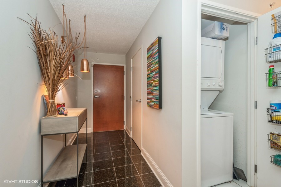 800 Elgin Road, Unit 517 Evanston, IL 60201 - Photo 3 of 20 a hallway with table and chairs