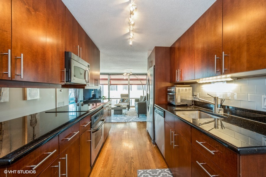 800 Elgin Road, Unit 517 Evanston, IL 60201 - Photo 7 of 20 a kitchen with stainless steel appliances a sink stove and cabinets
