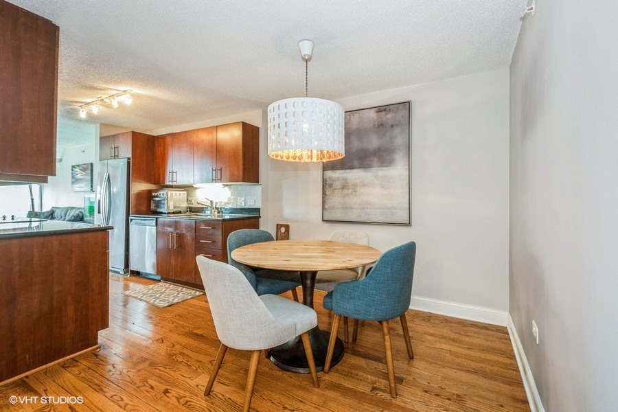 800 Elgin Road, Unit 517 Evanston, IL 60201 - Photo 9 of 20 a dining room with granite countertop wooden floor and a sink