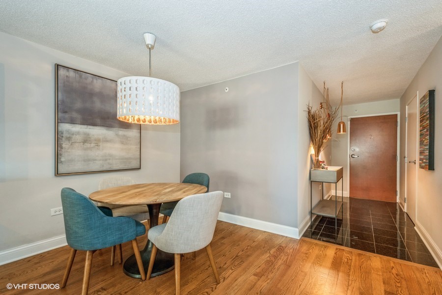 800 Elgin Road, Unit 517 Evanston, IL 60201 - Photo 10 of 20 a view of a dining room with furniture and wooden floor