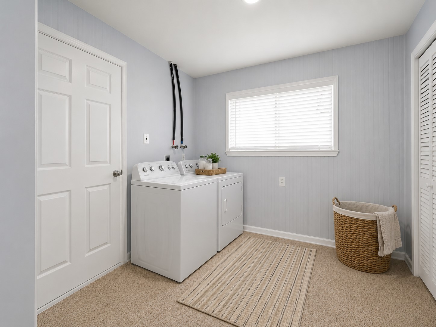 5443 Randon School Road Rosenberg, TX 77471 - Photo 17 of 20 Utility room with light paneled feature wall, washer/dryer hookups, window with blinds, and closet storage.