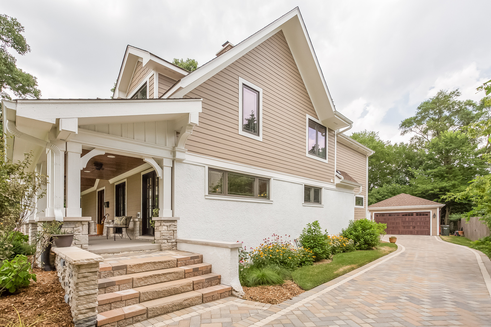 192 Riverside Road Riverside, IL 60546 - Photo 3 of 56 a view of a white house with large windows and potted plants