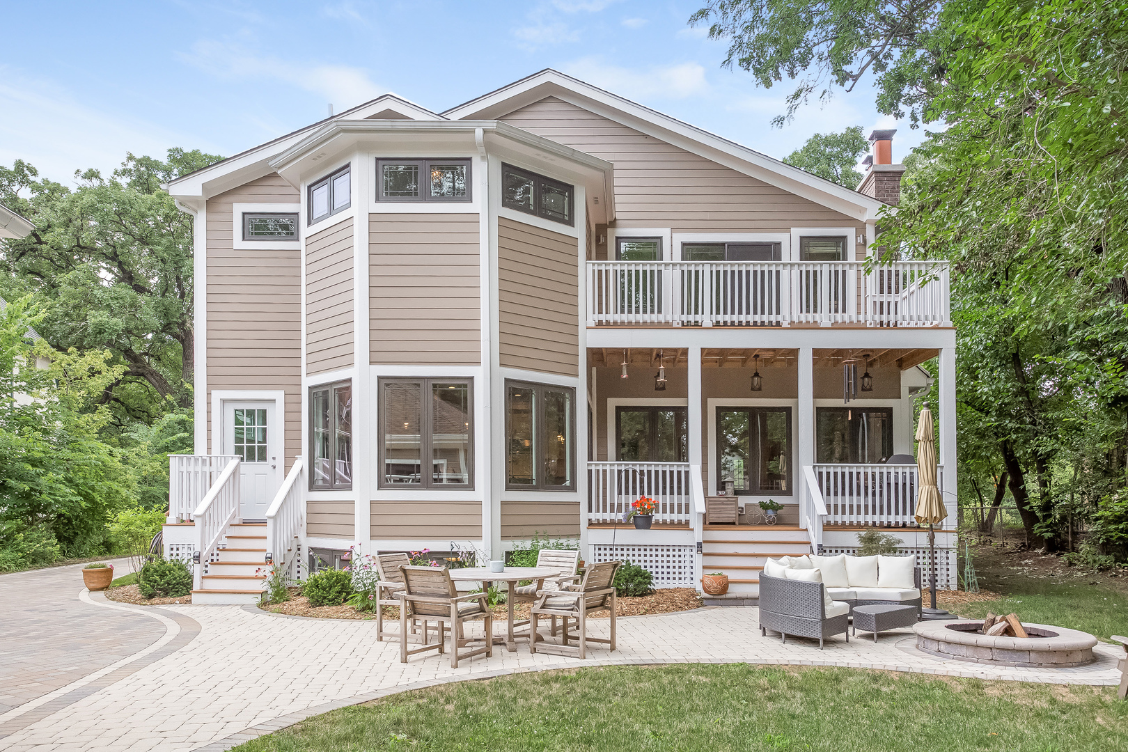 192 Riverside Road Riverside, IL 60546 - Photo 46 of 56 a front view of a house with a garden and chairs